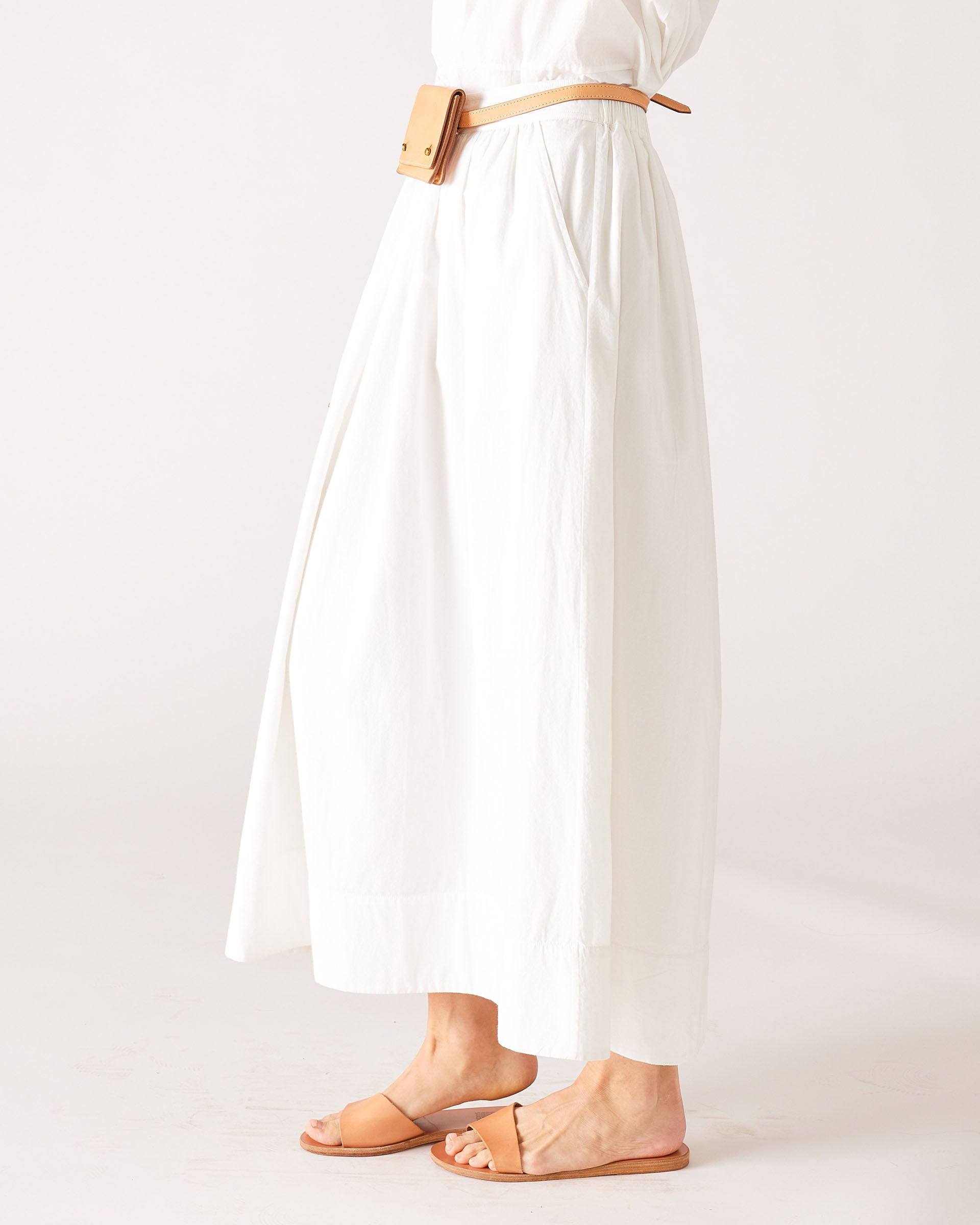 MERSEA women's travel-friendly ladies' travel-ready side view of white maxi skirt with a belt and matching pouch.