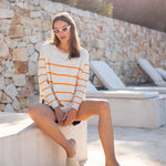 Womens White and Orange Striped Midweight Sweater Seated Travel Destination Look