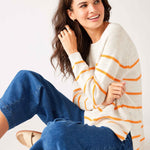 Womens White and Orange Striped Midweight Sweater Sitting Side View Arms Crossed