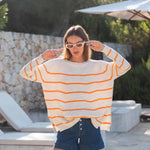 Womens White and Orange Striped Midweight Sweater Standing Travel Destination Look Hands on Head