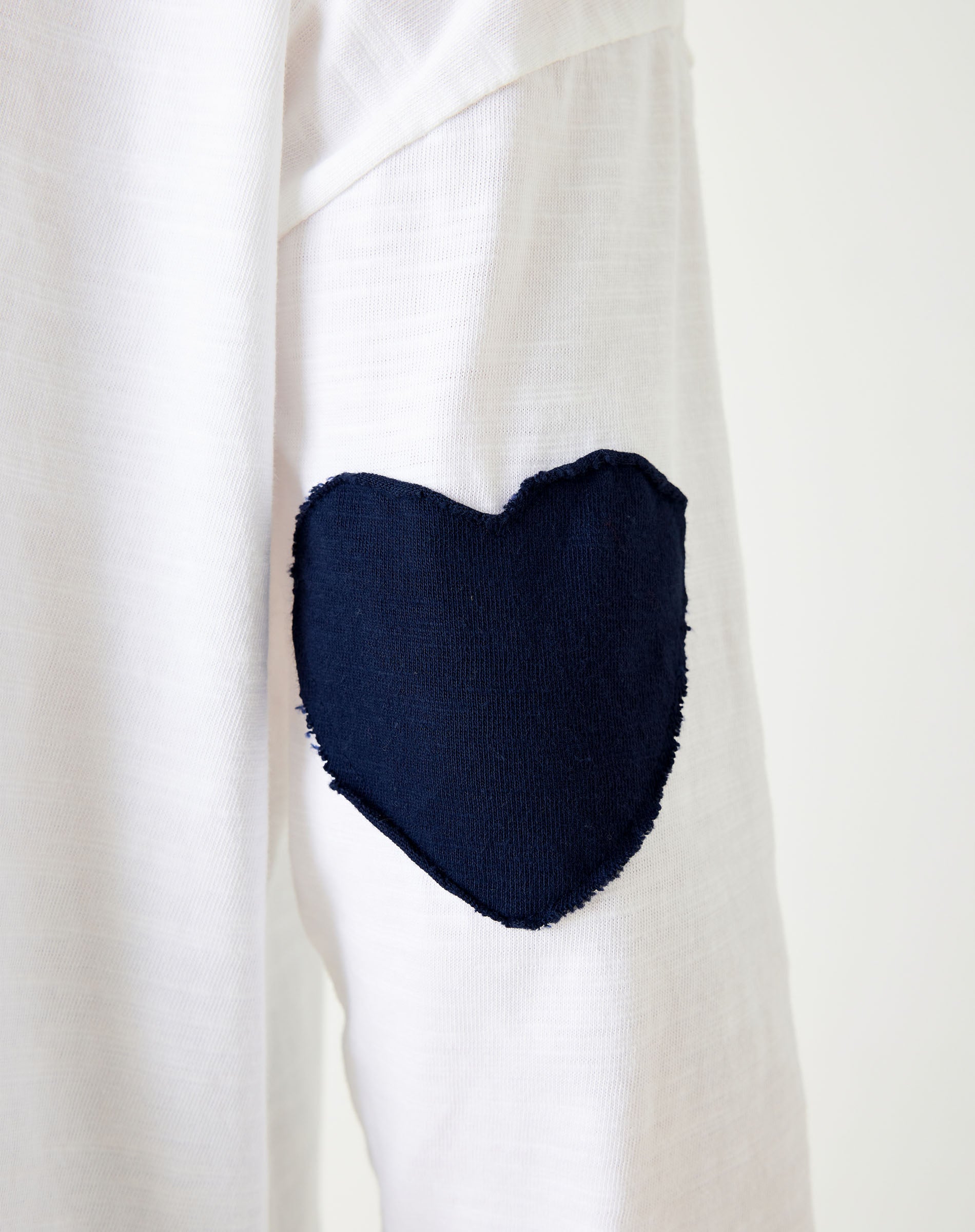 Women's White Oversized Tee with Navy Blue Heart Patch on Elbow