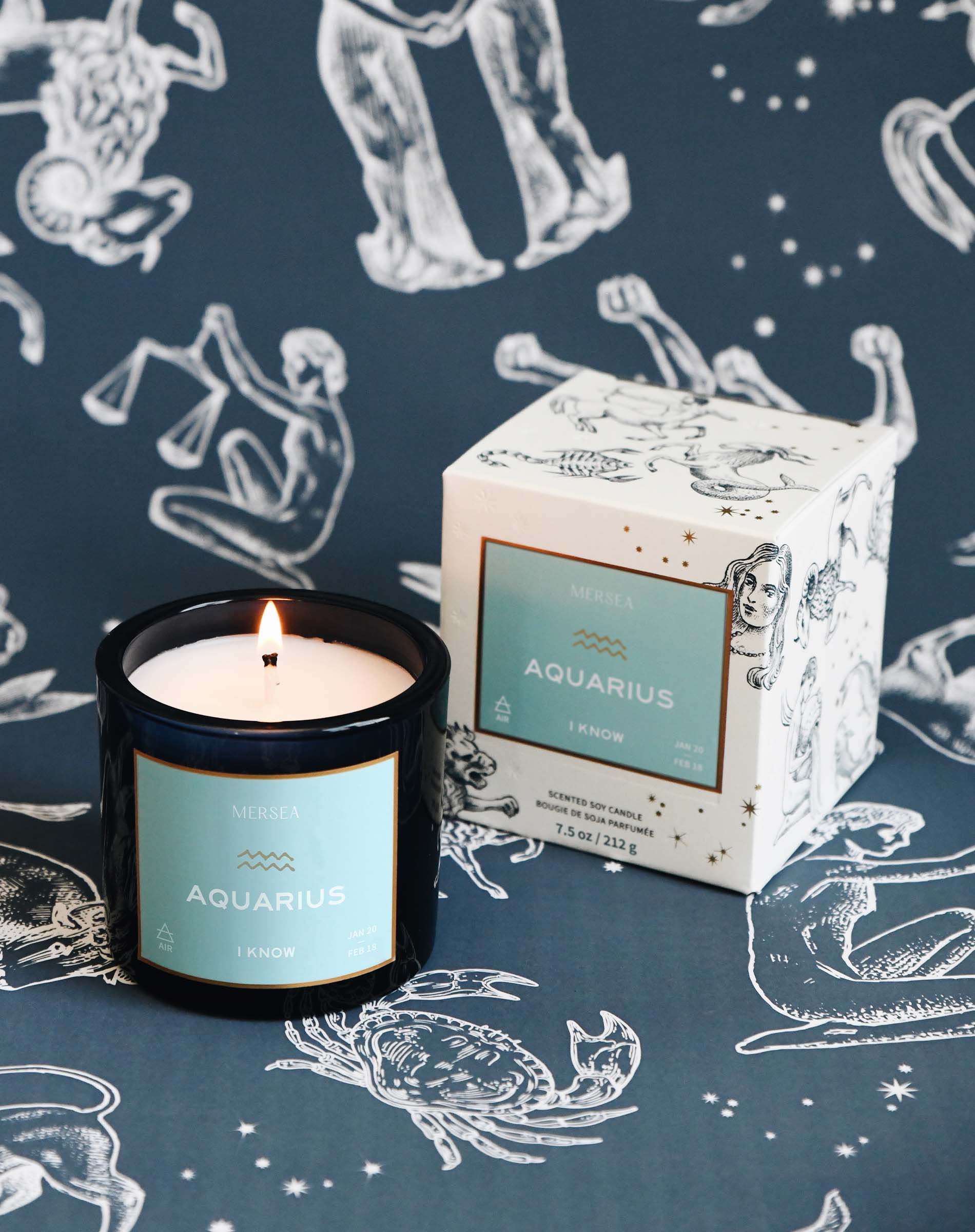 Candle and packaging with 'Aquarius' theme on a zodiac patterned background