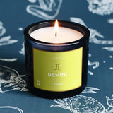Candle labeled 'Gemini' by Mersea on a blue background with astrological designs