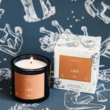 Leo candle and packaging on a dark blue background with astrological illustrations
