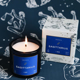 Sagittarius candle with matching box on a zodiac-themed background