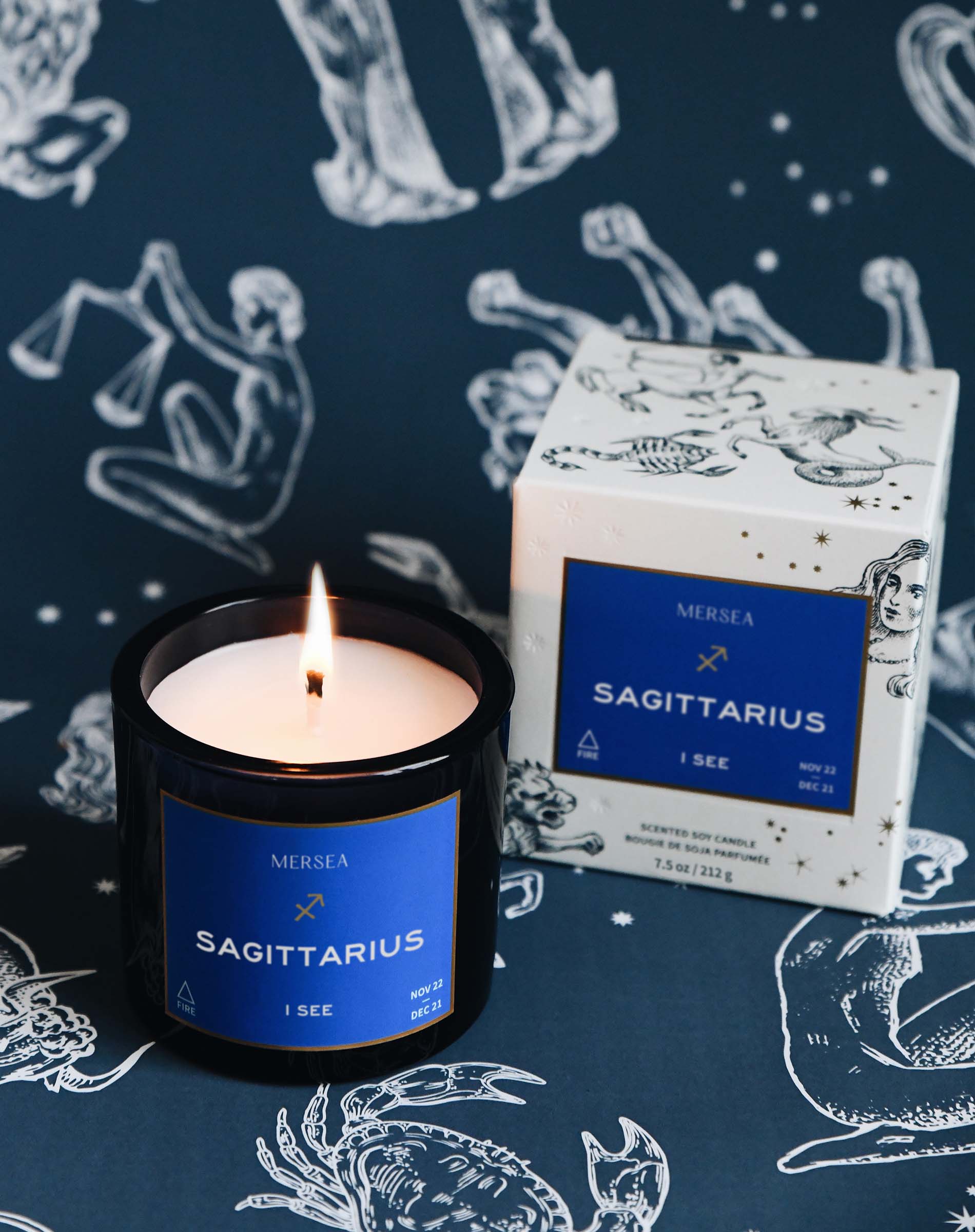 Sagittarius candle with matching box on a zodiac-themed background