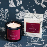 Mersea Scorpio candle and packaging on a zodiac-themed background
