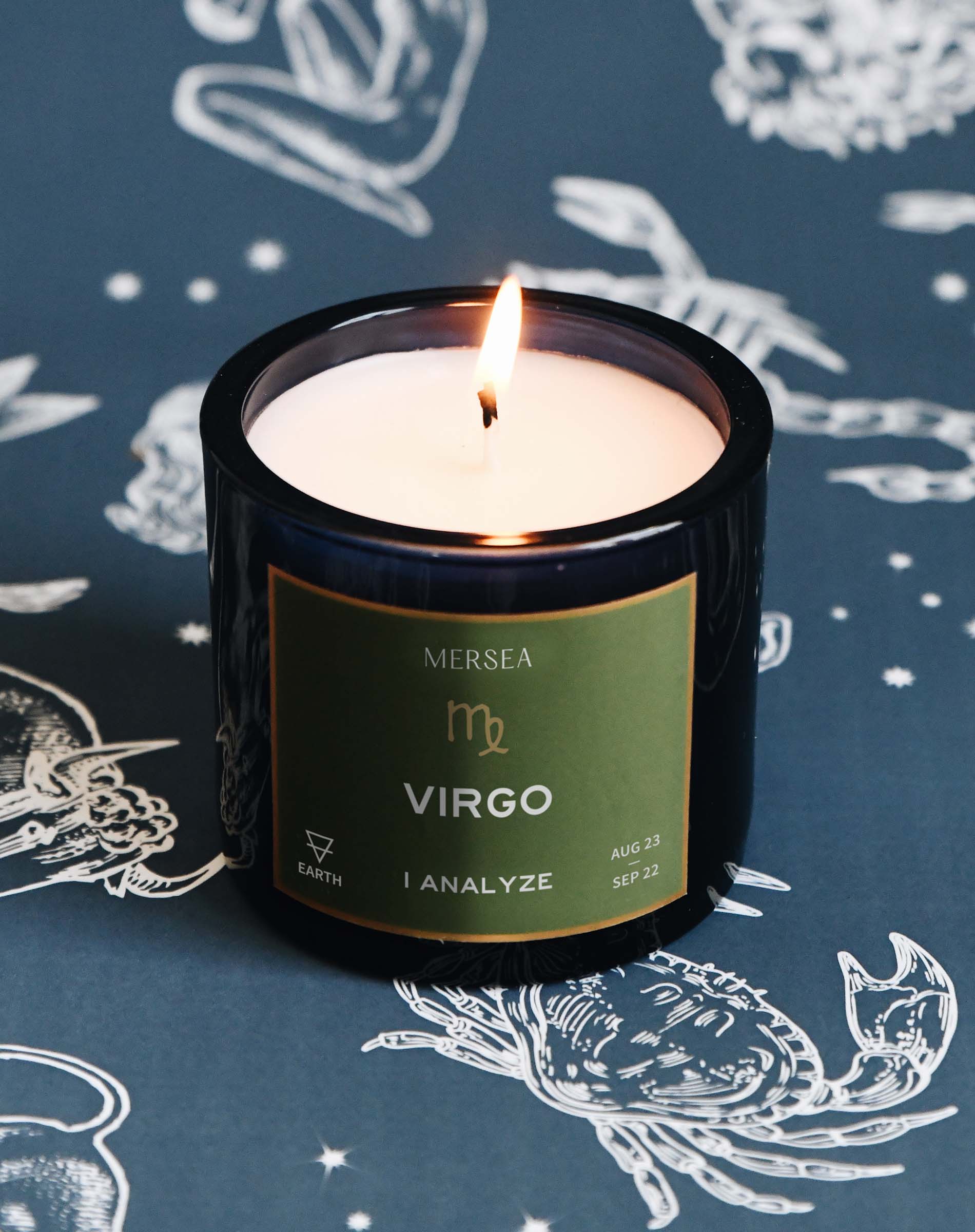 Candle with a 'Virgo' label on a blue background with zodiac illustrations