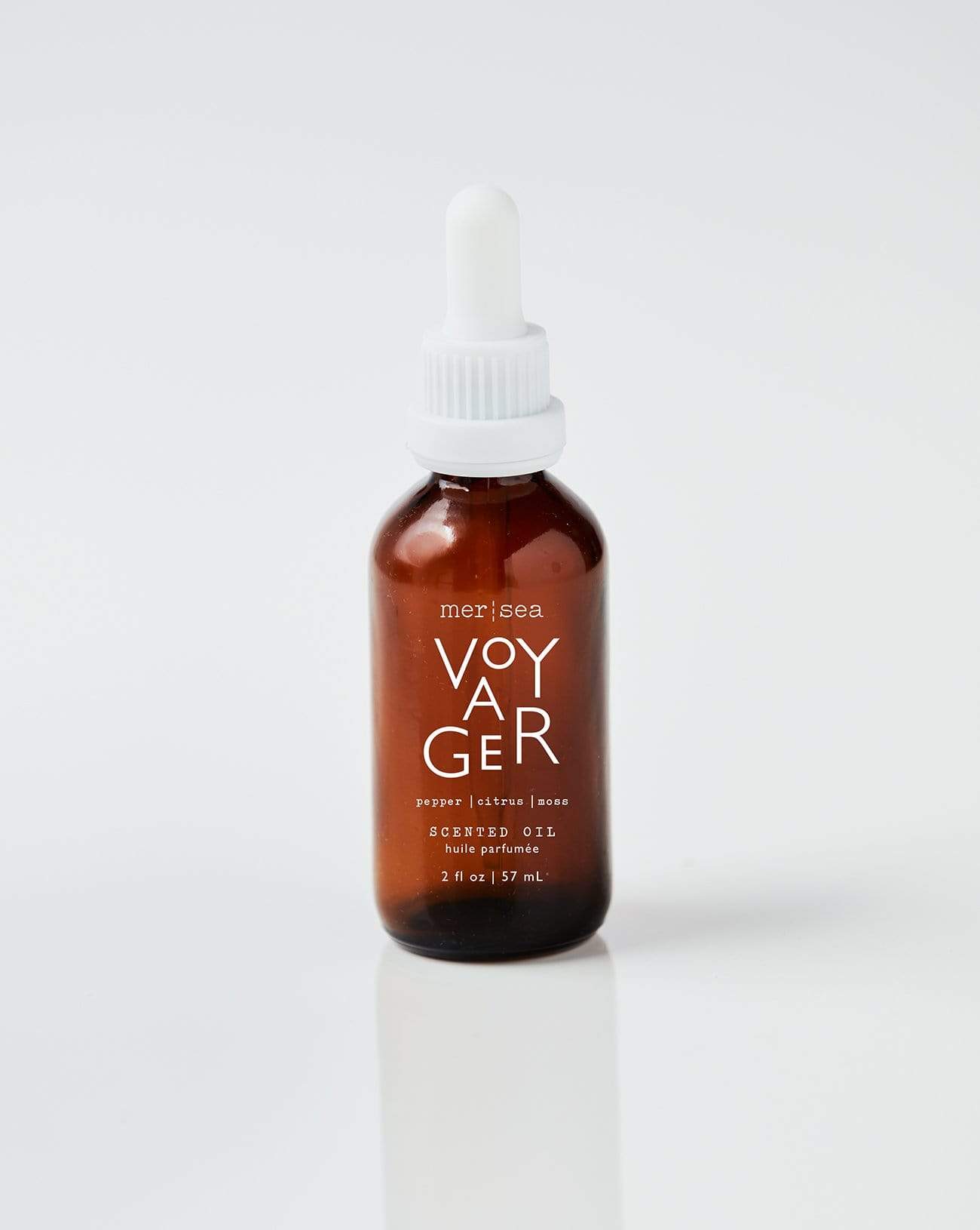 small bottle of voyager scented oil on a white background