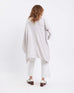 rear view of woman wearing mersea charleston travel wrap in whisper white color against white background