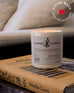 white ceramic cooper candle sitting on top of books on a side table near a couch 