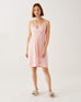 female wearing light pink satin pajama sleep dress on a white background