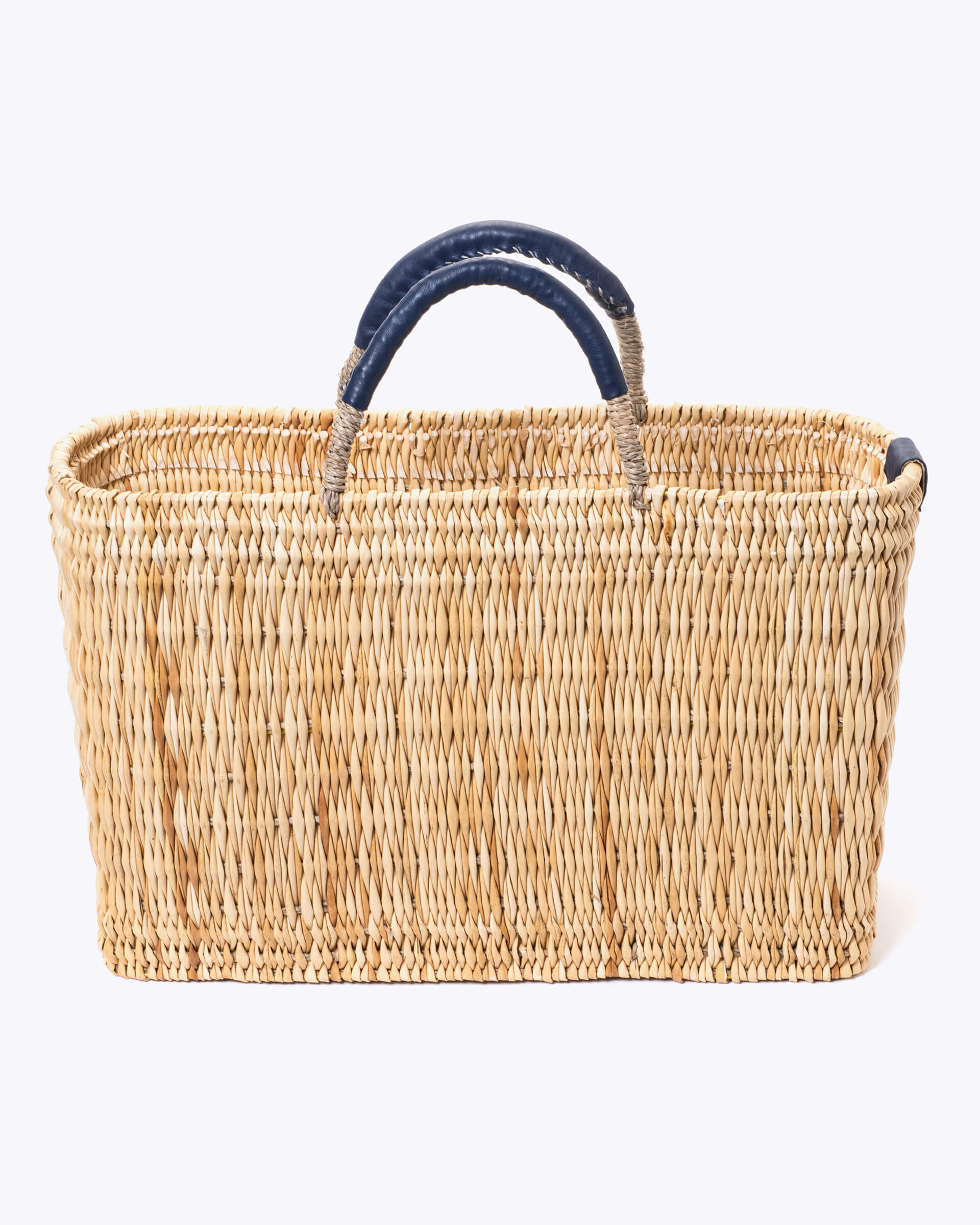 medium straw basket wrapped with dark blue leather handle on a white background