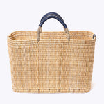 large straw basket wrapped with dark blue leather handle on a white background