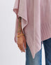 close up of female wearing light pink wrap focused on the bottom rib hemline on white background