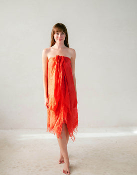 female wearing vermillion linen wrap tied in front 
