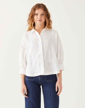 female wearing white linen shirt with button-down and collar on white background
