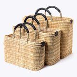 small, medium, large straw basket wrapped with black leather handles on white background