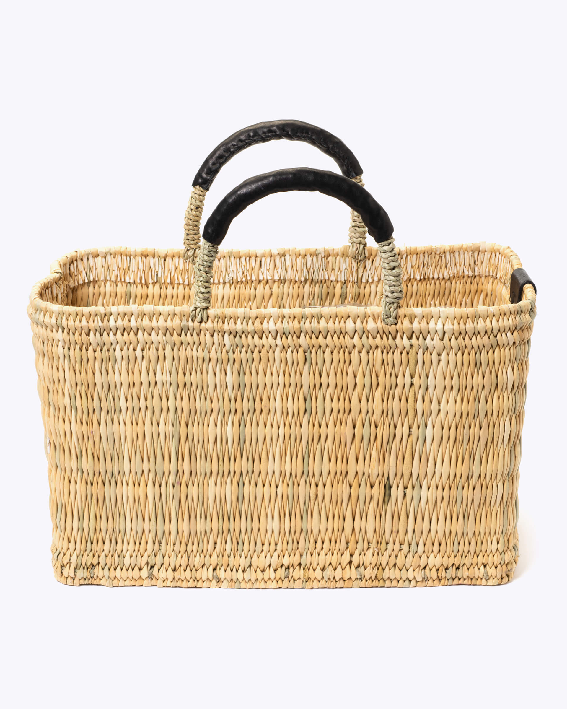 medium straw basket wrapped with black leather handle on a white background