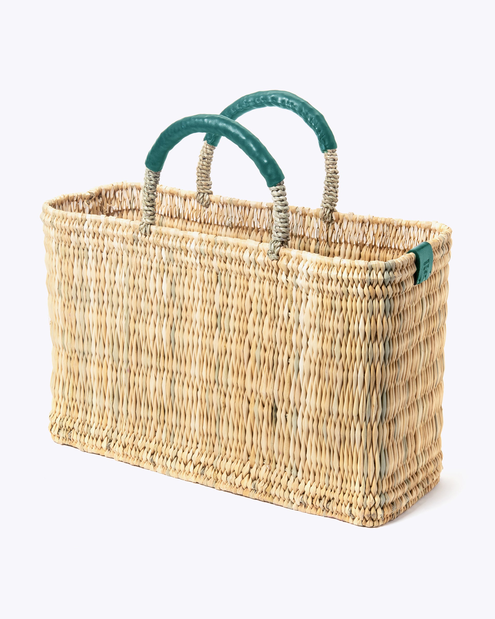 medium straw basket with jade leather handles and  imprint of always by the sea on a white background