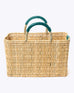 medium straw basket with jade leather handles and imprint of always by the sea on a white background
