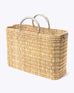 large straw basket wrapped with neutral leather handle on a white background at an angle