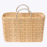 large straw basket wrapped with neutral leather handle on a white background 