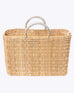 large straw basket wrapped with neutral leather handle on a white background 