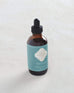 small bottle of moroccan mint scented oil burner with blue marrakesh label on white background