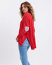 profile of woman wearing Amour Sweater in Red and white heart elbow patch