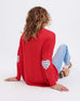 rearview of woman sitting wearing Amour Sweater in Red and white heart elbow patch