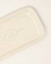 white rectangle ceramic soap tray with designs in the center on a white background