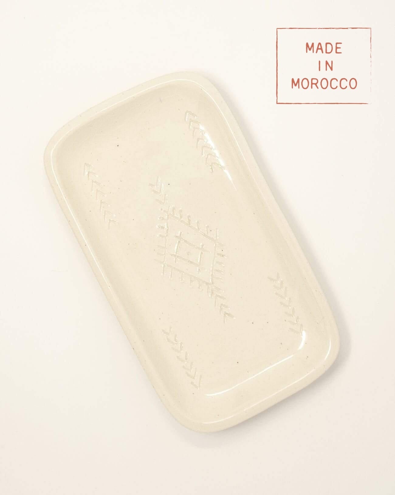 white rectangle ceramic soap tray made in morocco with designs in the center on a white background