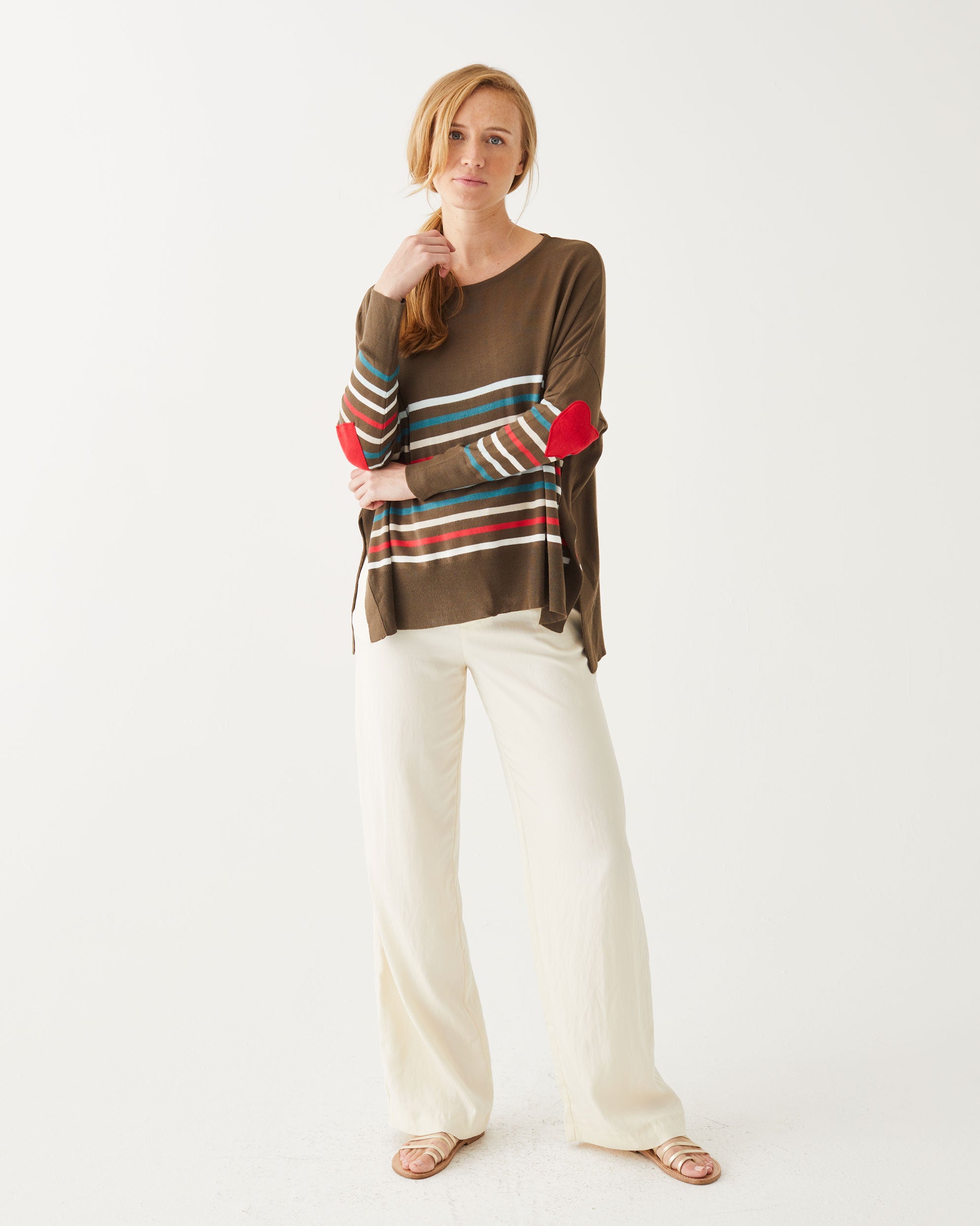woman wearing Brown amour Sweater in multicolor stripes with red heart elbow patch