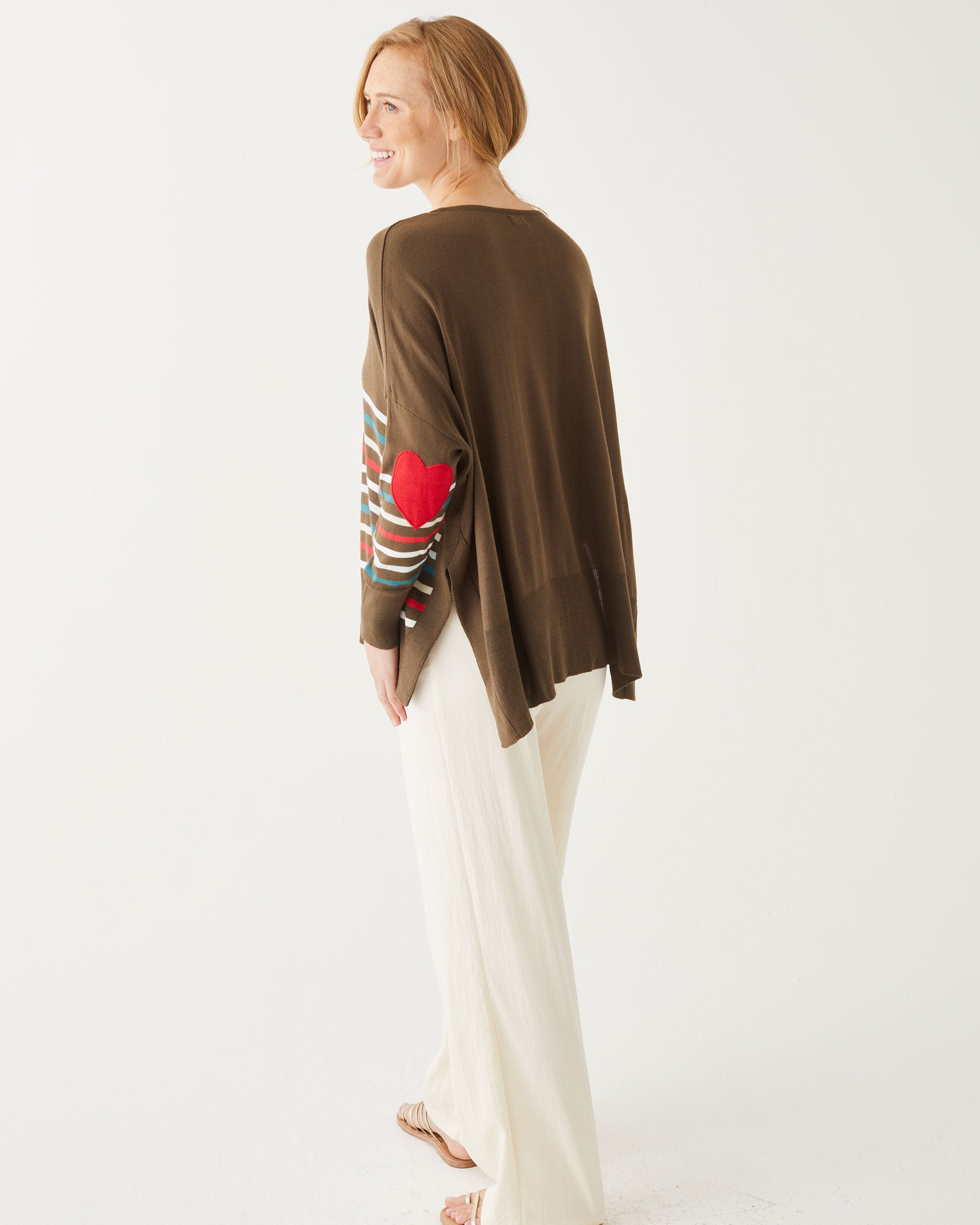 rearview of woman wearing Brown amour Sweater in multicolor stripes with red heart elbow patch