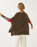 rearview of woman wearing Brown amour Sweater in multicolor stripes with red heart elbow patch