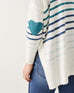 female wearing white and blue striped sweater withblue  heart elbow patch on white background