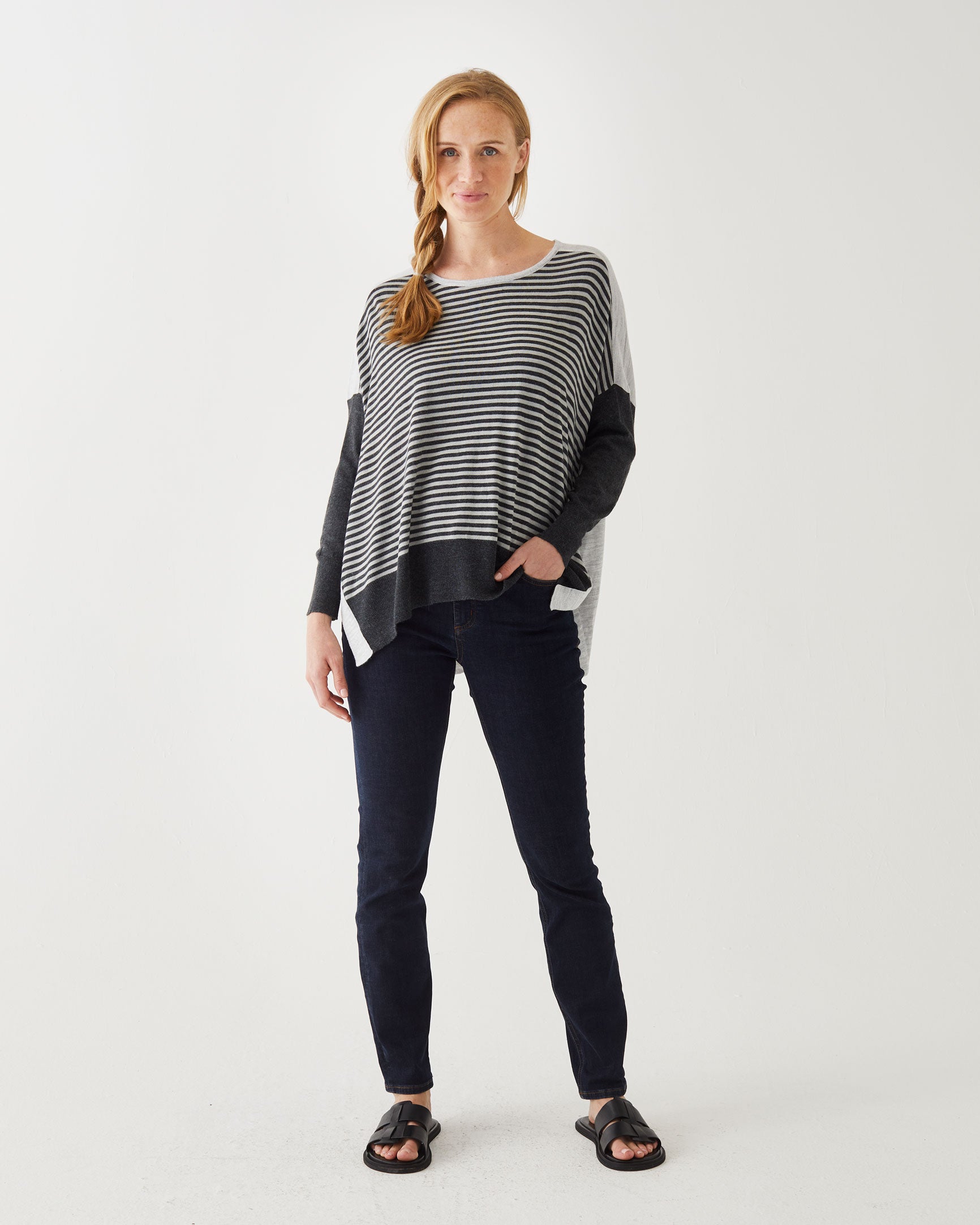 woman wearing Amour Sweater in grey stripes with grey heart elbow patch