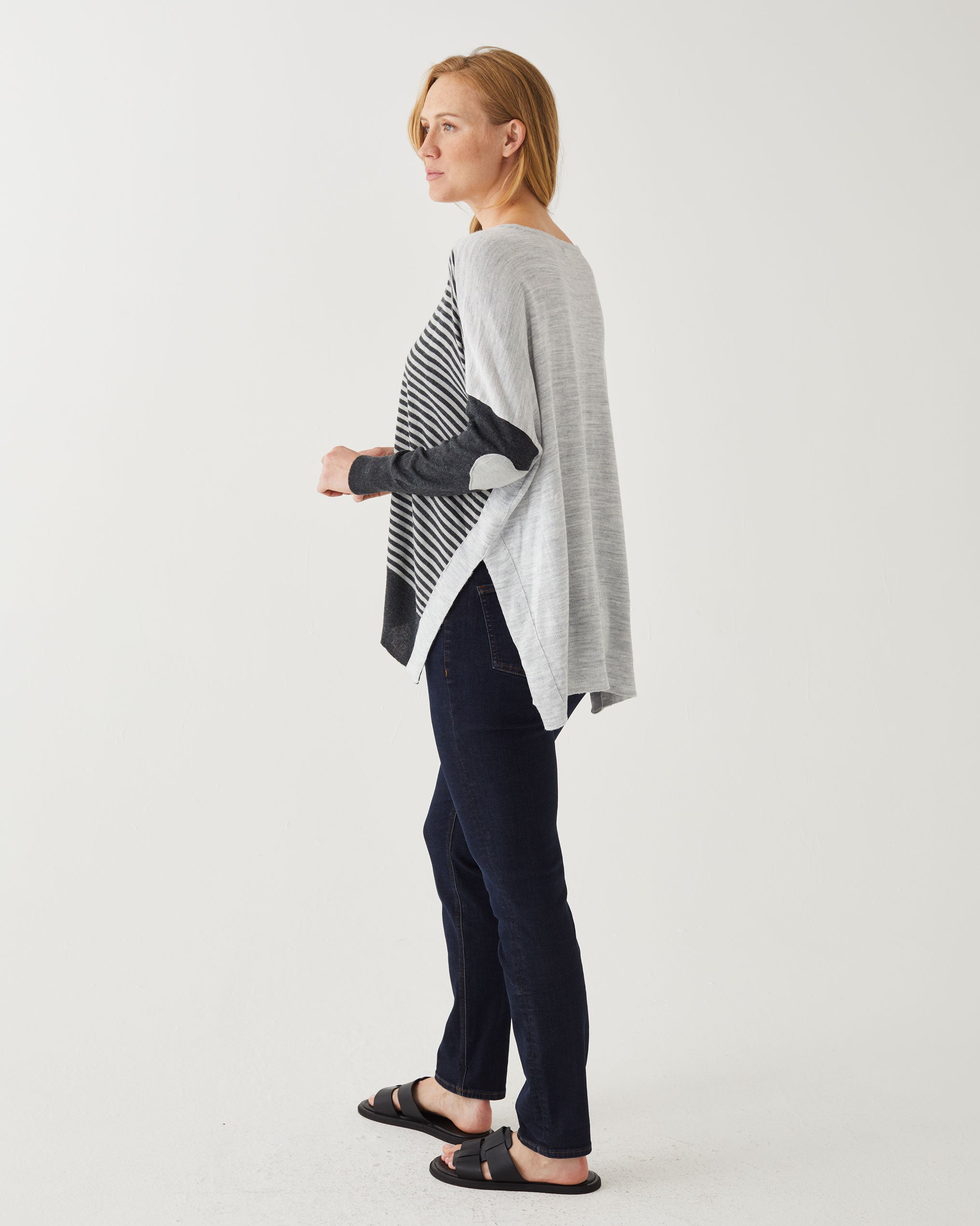 profile of woman wearing Amour Sweater in grey stripes with grey heart elbow patch