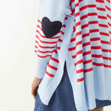 female wearing blue and red striped sweater with a heart elbow patch on a white background