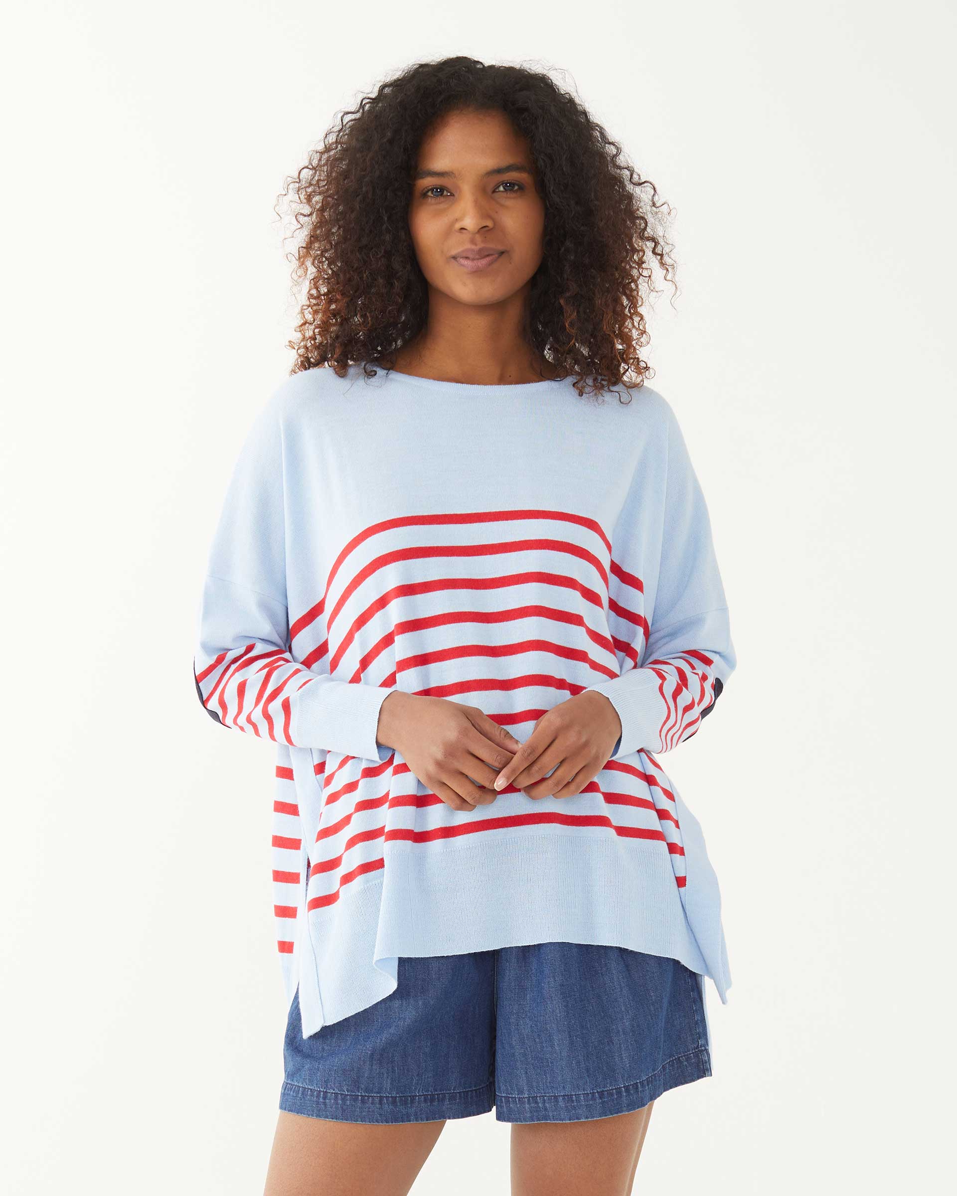 female wearing blue and red striped sweater with a navy heart elbow patch on a white background