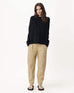 woman with hands in pockets  wearing mersea banff sweater in black