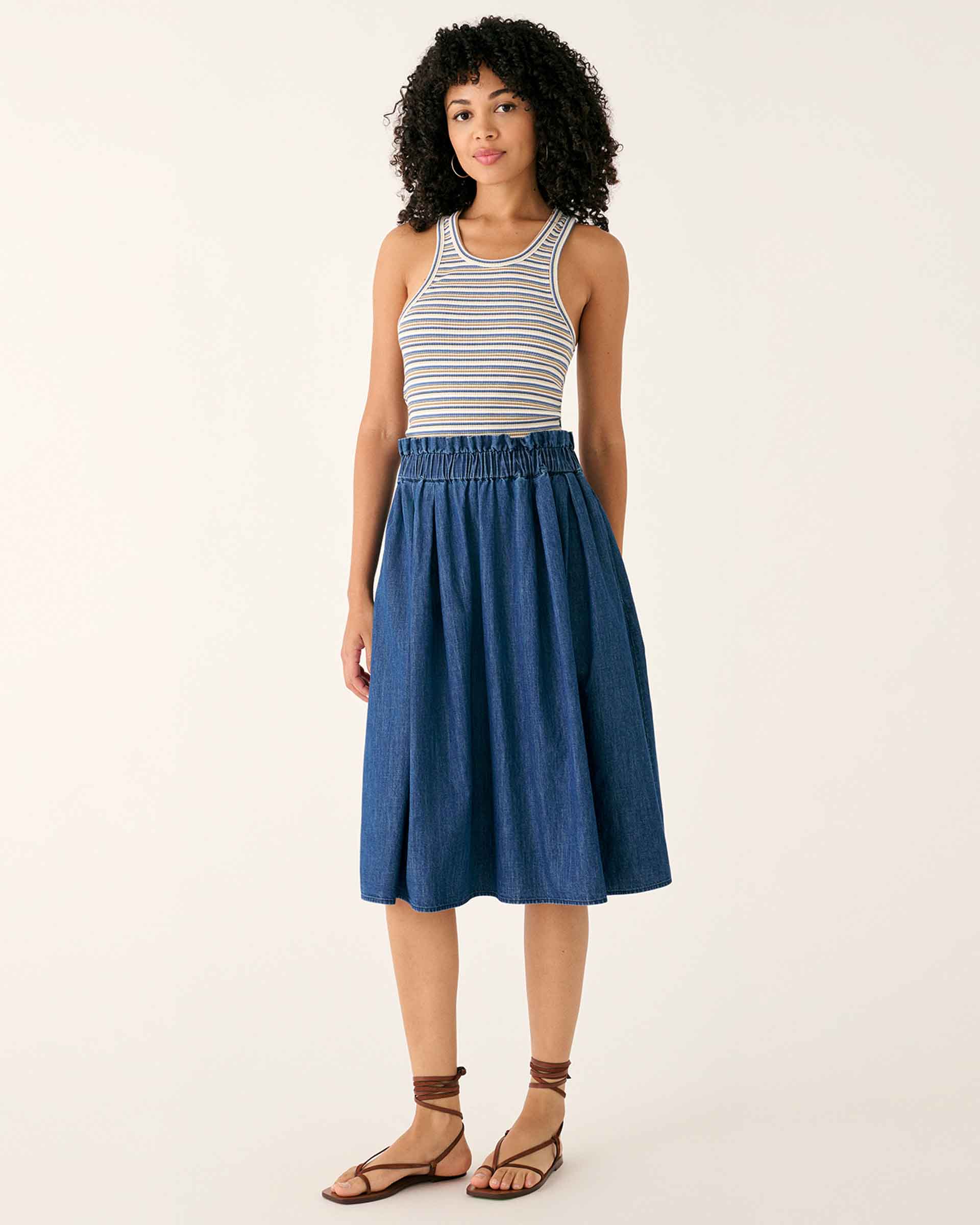 female wearing chambray midi A-line skirt with elastic waist standing on a white background