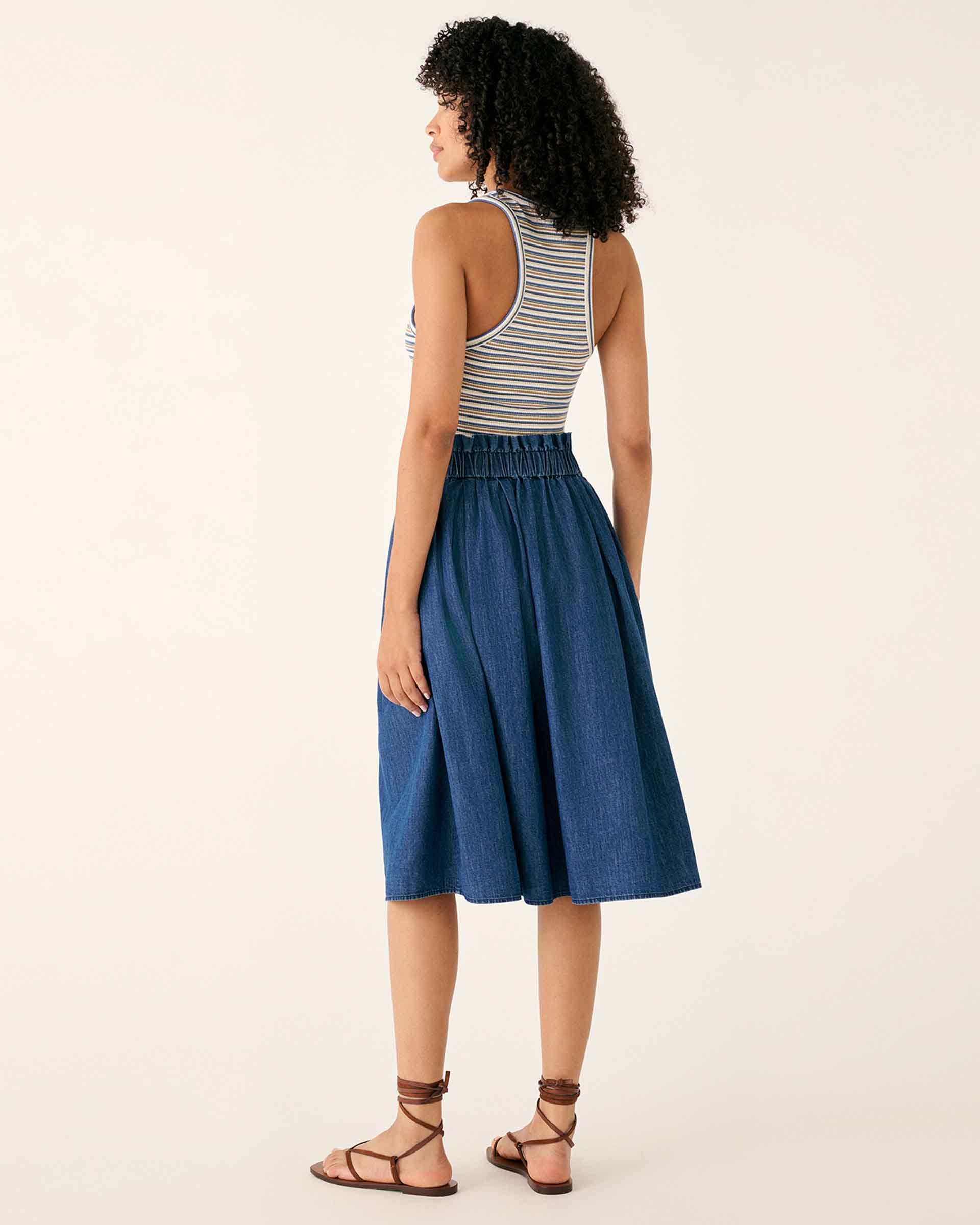 female wearing chambray midi A-line skirt with elastic waist backwards on a white background