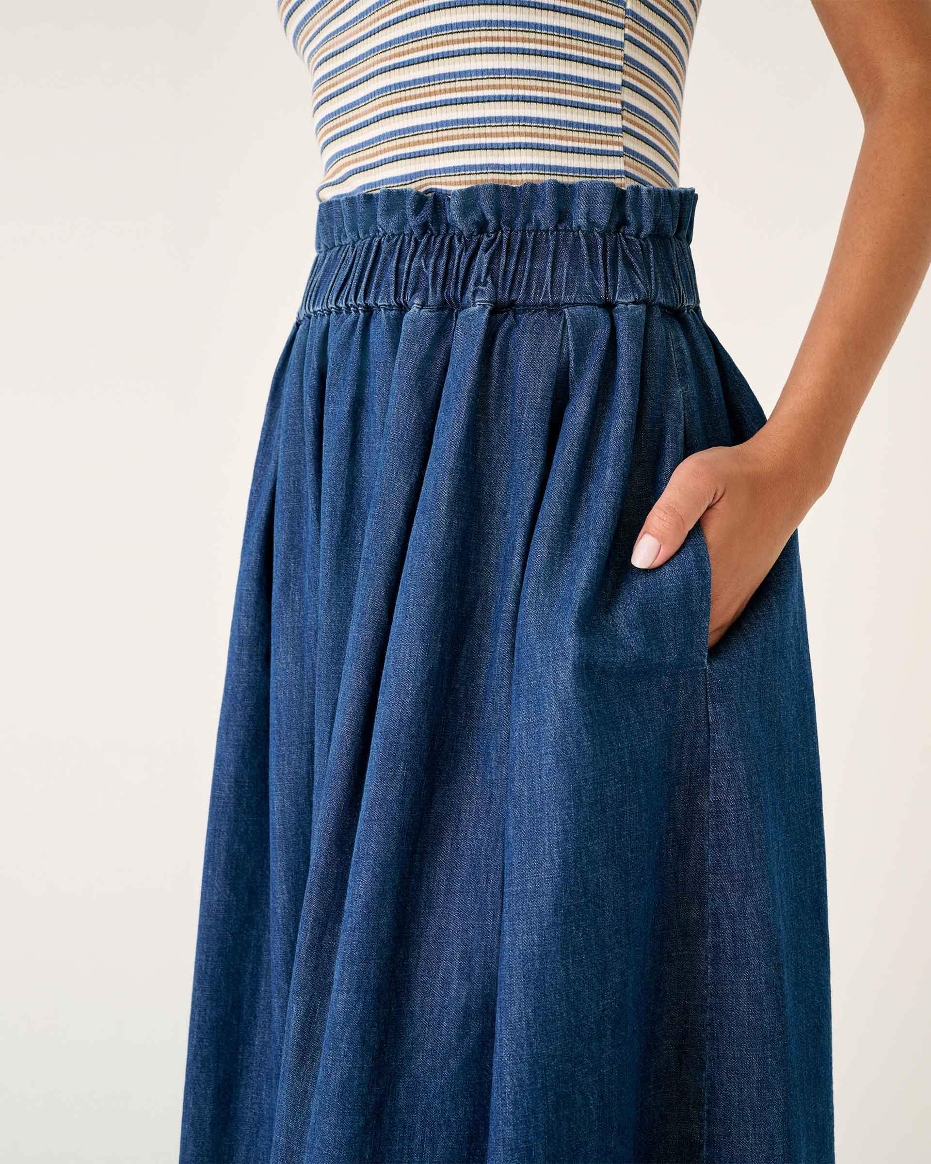 close up of female wearing chambray midi A-line skirt with elastic waist on a white background
