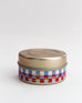 blue and red checkered 3 oz OUI! candle on a white background