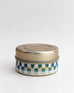 blue and white checkered 3 oz sea change candle on a white background