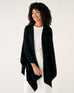 woman wearing mersea black charleston cotton cashmere wrap standing on a white background