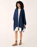 woman wearing mersea blue chambray charleston cotton cashmere wrap standing on a white background
