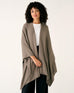 woman wearing mersea brown charleston cotton cashmere wrap standing on a white background